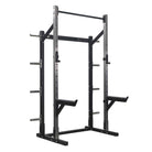 A black half rack machine with safety bars, weight hangers, barbell hangers, and a chin rack.