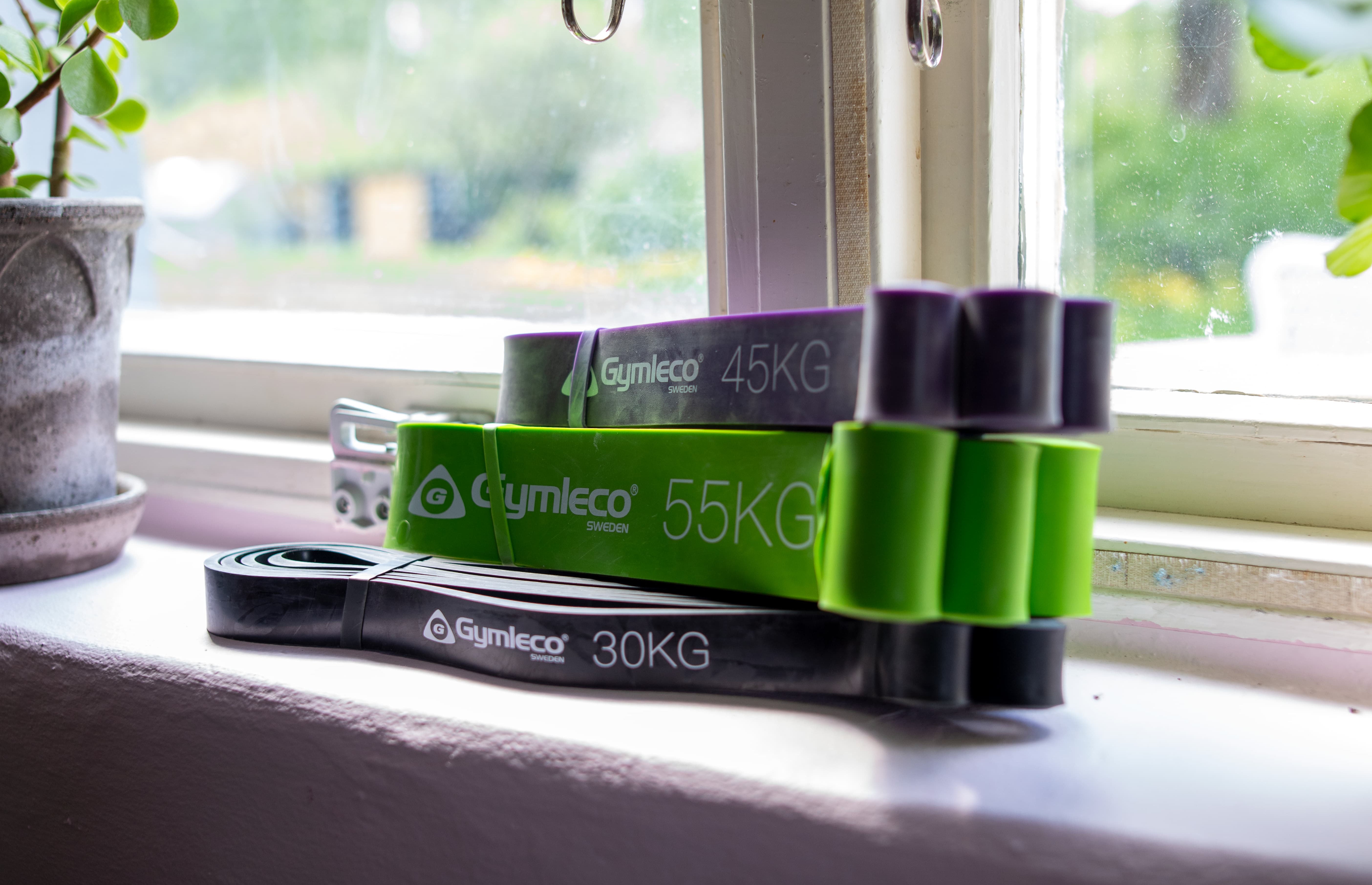 Set of resistance bands with weights on a windowsill