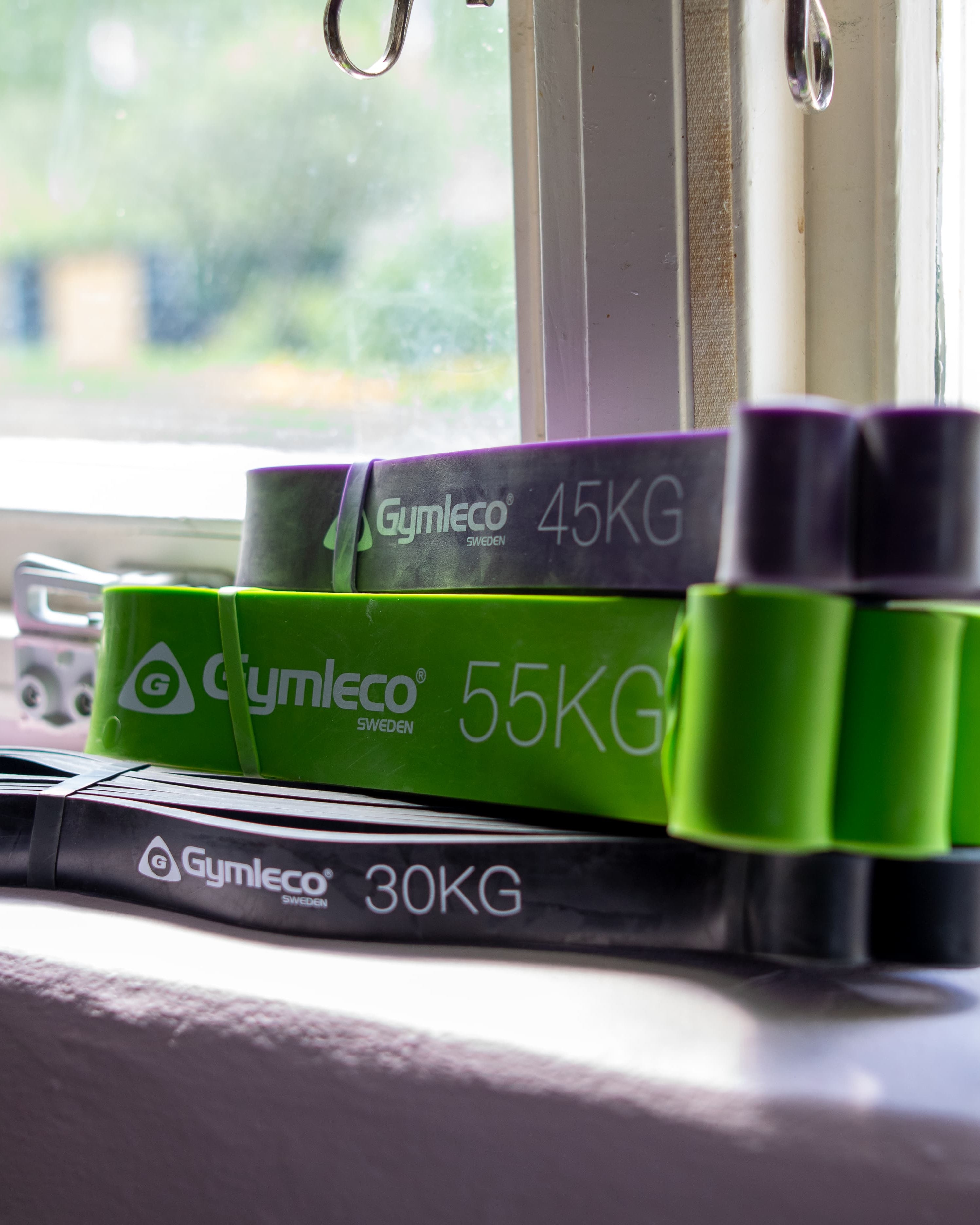 Set of resistance bands with weights on a windowsill