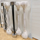 828 Gymleco barbell standing on a wooden floor with a white wall behind
