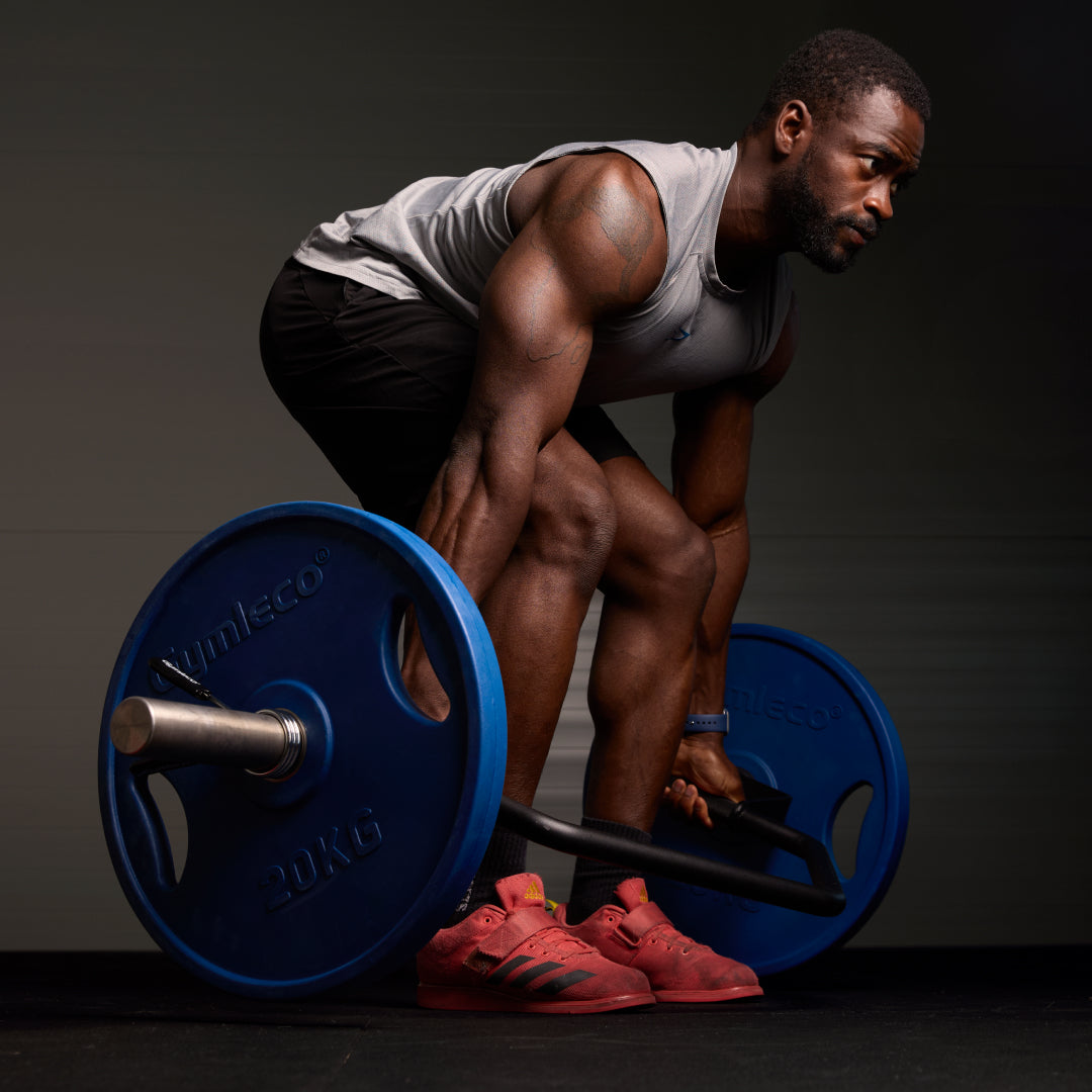 Athlete lifting a barbell with blue weights on a dark background