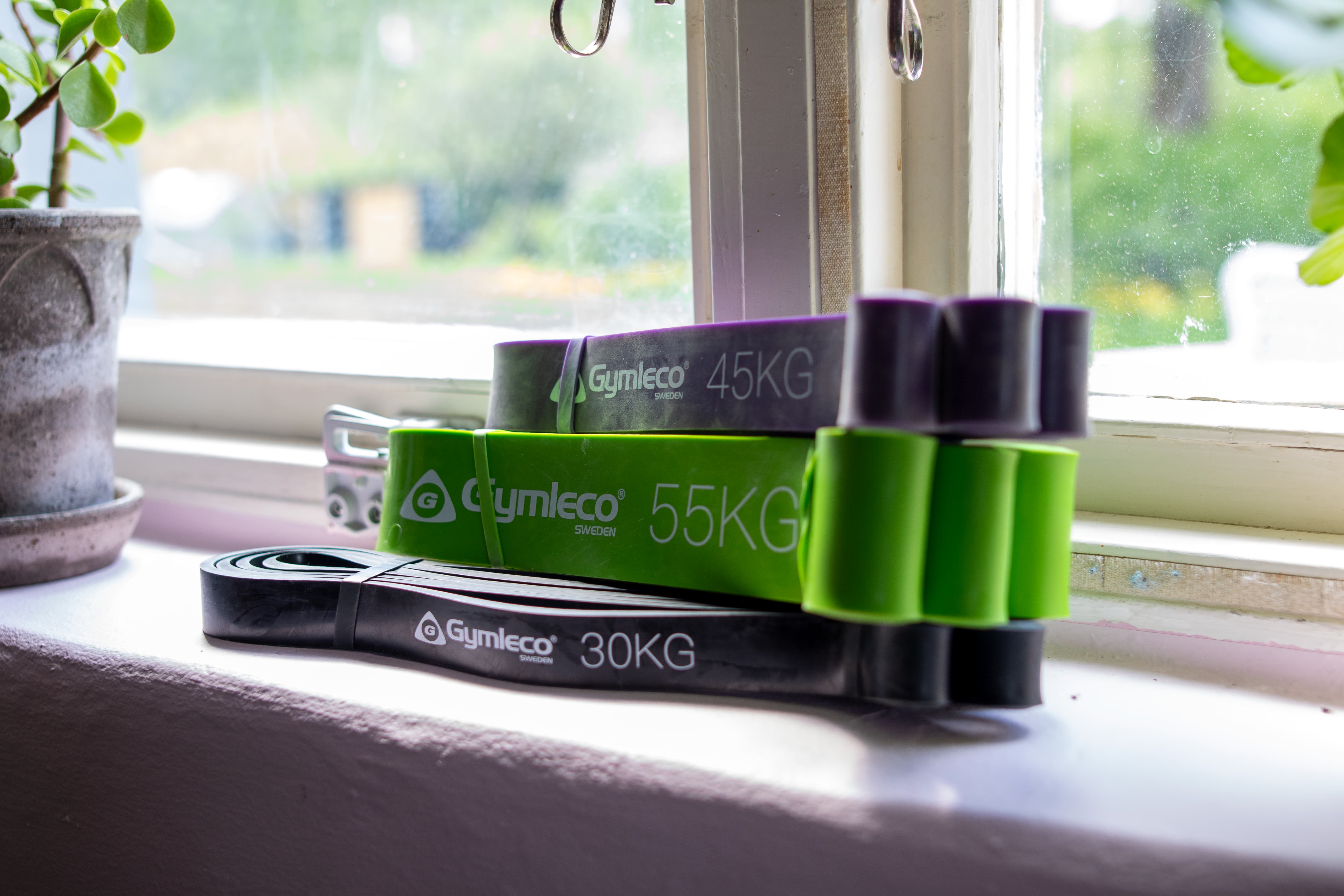 Set of resistance bands with weights on a windowsill